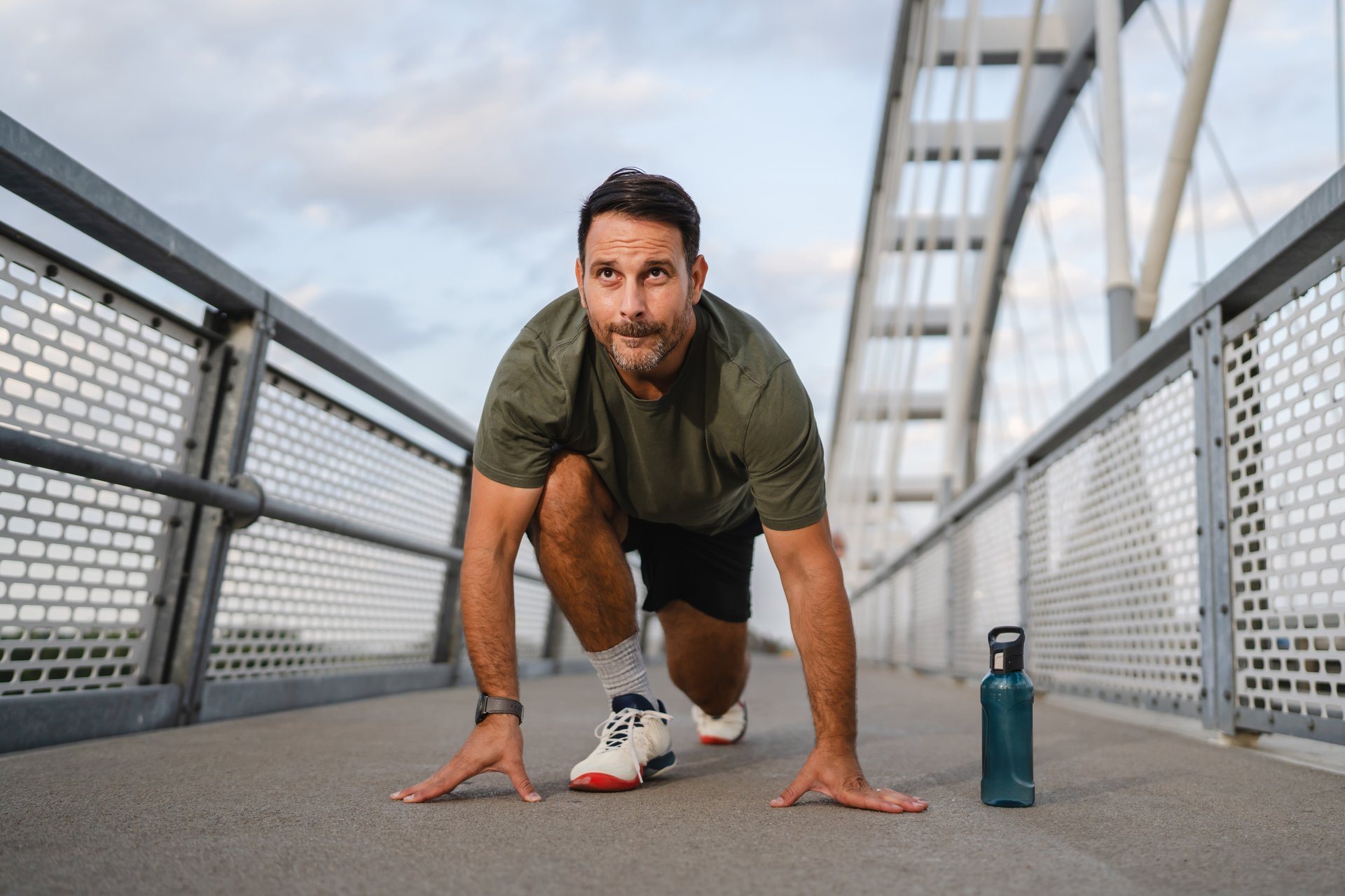 Mature man running outdoors, focused and determined